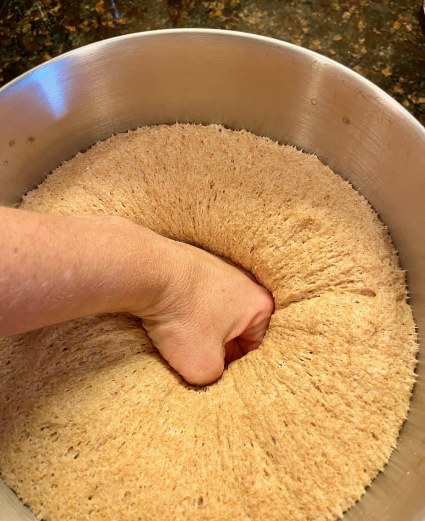 fluffy bread dough being punched down