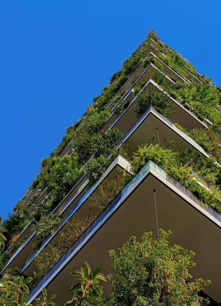 high building with plants growing off balcony