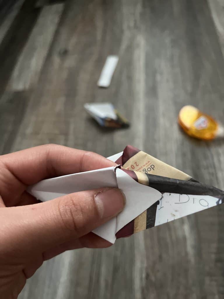 two origami cones being put together by open end