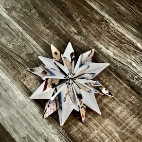 Finished origami ornament against rustic background