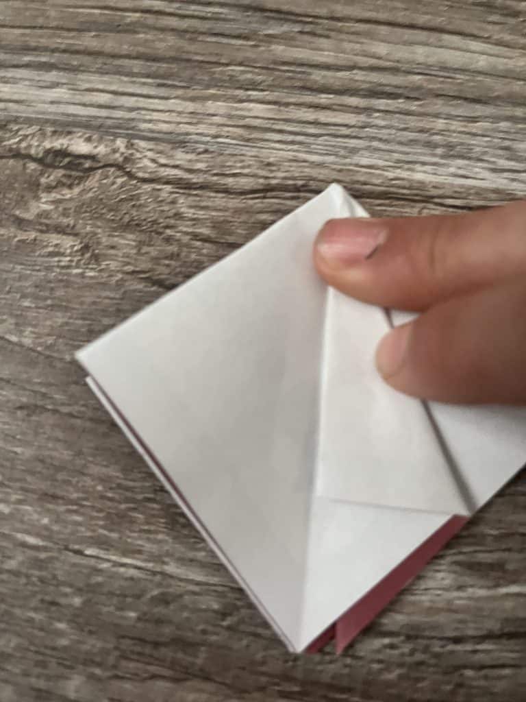 fingers folding piece of paper