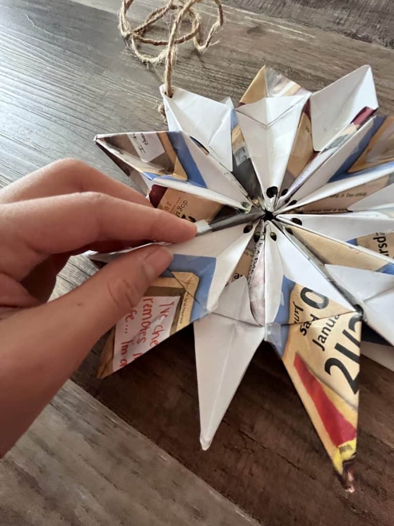 multiple origami stars strung together to make a big snowflake