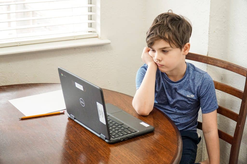 frustrated child in front of laptop